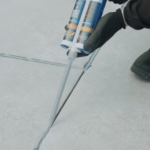 Joint-It Porcelain Epoxy Grout being applied in patio joints with an application gun