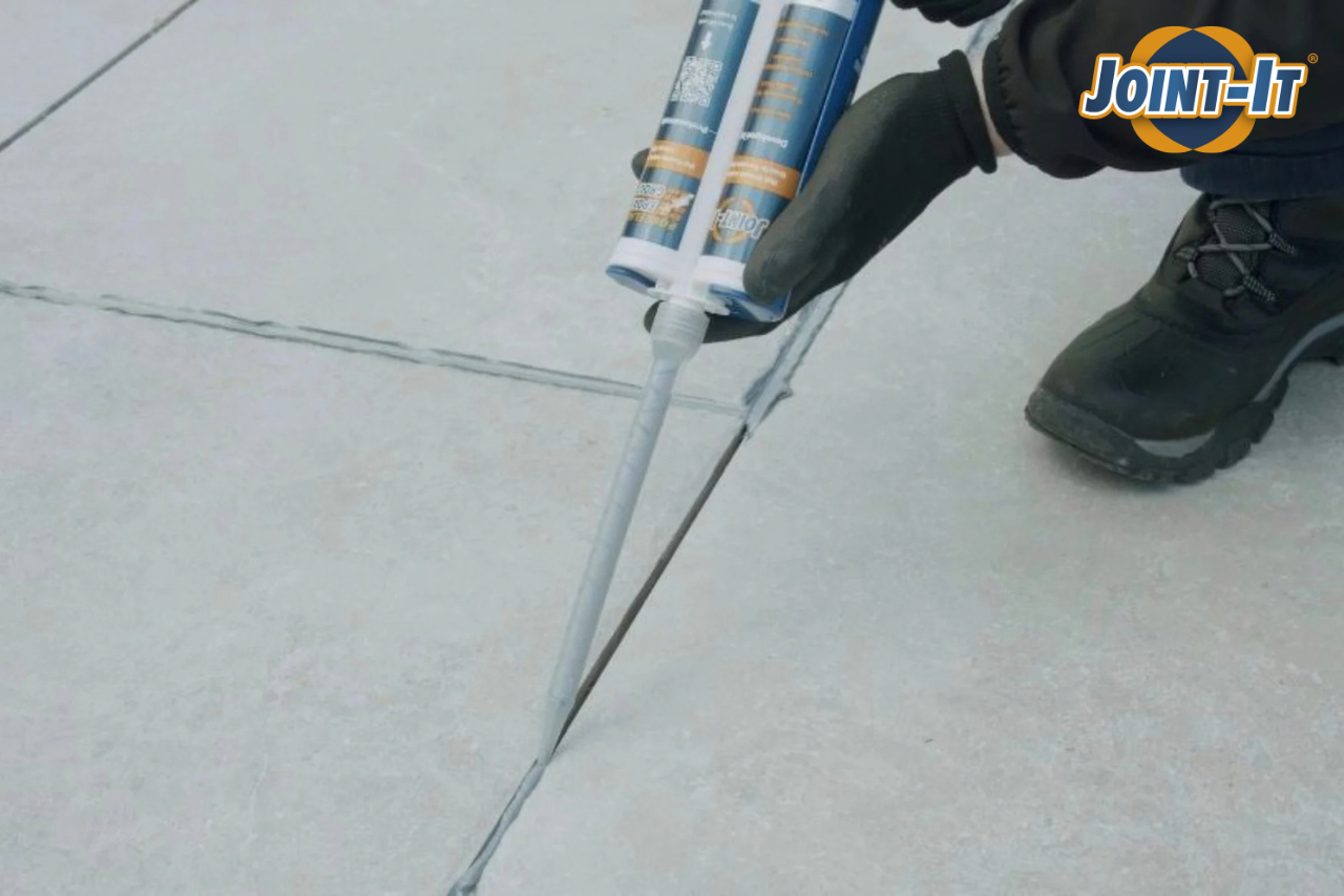 Joint-It Porcelain Epoxy Grout being applied in patio joints with an application gun